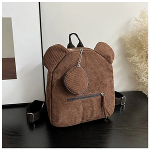 Detail eines braunen Cord-Rucksacks mit Bärenohren und passender runder Geldbörse