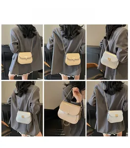 Detailed views of crossbody bag with oversized heart buckle and elegant gold chain strap