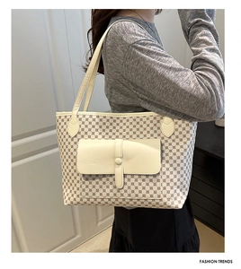 Detailed view of the flap buckle pocket and geometric pattern on the shoulder bag