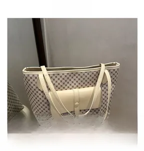 Detail view of large tote bag showing geometric patterns and front leather pocket