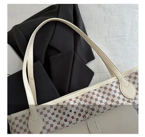 Close-up of the vintage geometric print and ivory stitching on a luxury tote bag