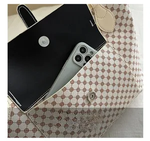 Detail of floral tote bag showing magnetic clasp, interior pocket and phone storage