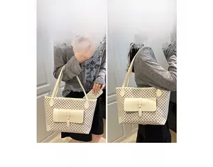 Detail of cream checkerboard tote bag showing front pocket and dual strap styling