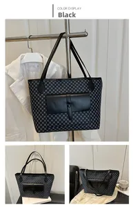 Detail of a large black tote bag with textured dots and front leather flap pocket