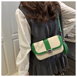 Detail of French vintage crossbody bag with white woven texture and green leather trim