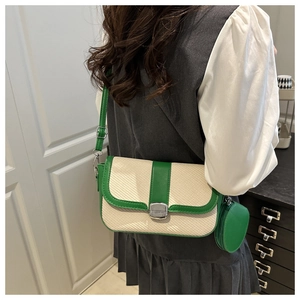 Model wearing a retro green and beige woven underarm bag with small round coin purse