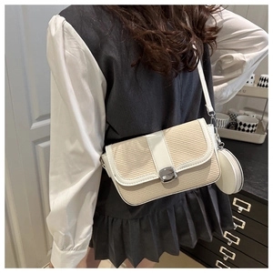 Close-up of beige woven crossbody bag with white leather trim and mini coin purse