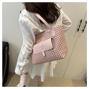 Rear view of pink tote bag with geometric pattern and smooth flap pocket on female model