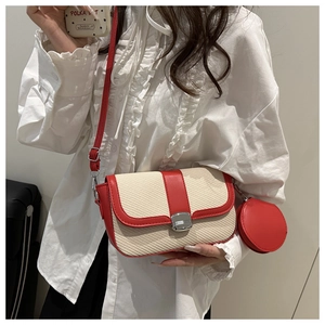 Close-up of contrast color straw crossbody bag with metal buckle and round coin purse