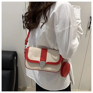 Fashionable woven crossbody saddle bag with red leather trim and round coin purse detail