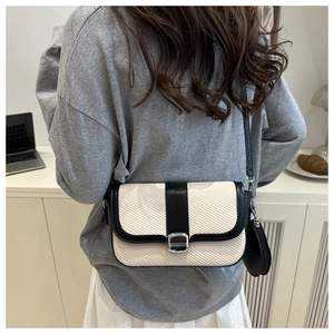 Detail of crossbody bag with knit texture, leather panels and detachable coin purse