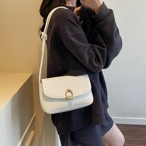 Elegant white leather saddle bag with gold horseshoe buckle and knotted shoulder strap