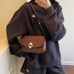 Retro brown leather saddle bag with gold horseshoe clasp and slim shoulder strap