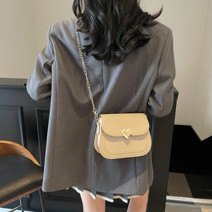 Cream patent leather square crossbody bag with gold heart buckle and chain strap