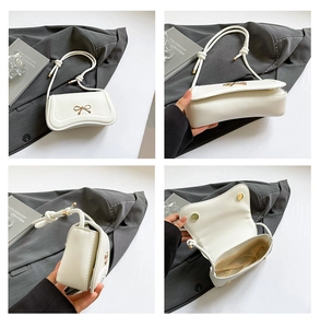 Detailed views of white crossbody bag with golden bow and interior storage space