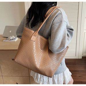 Detailed view of brown woven texture and spacious interior of the retro tote bag