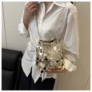 Detail of sequined bucket bag with gold and silver paillettes and silver chain strap