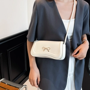 Elegant beige crossbody bag for women with golden bow buckle and smooth PU finish