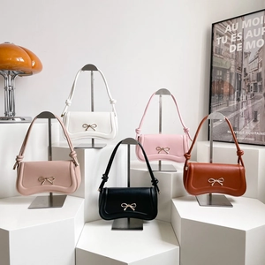 Fashionable bow-knot underarm bags in five colors with sleek curved leather design