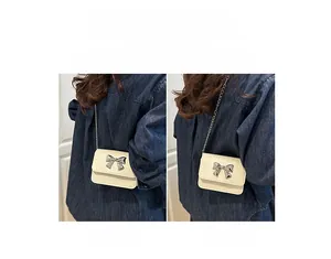 Detailed views of beige mini chain bag shown in crossbody and shoulder carry styles