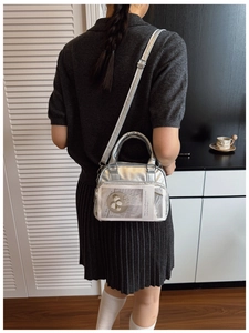 Silver metallic crossbody bag with clear PVC front pocket and adjustable shoulder strap