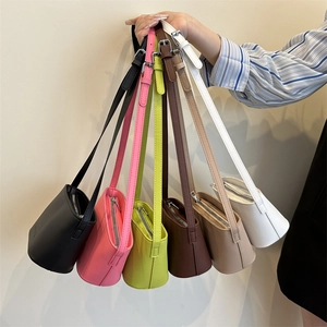 Minimalist leather bucket bags in six colors with adjustable straps and zipper closures