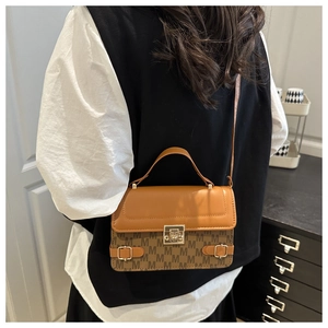 Brown monogram tote bag styled on model shoulder showing size and carry proportions
