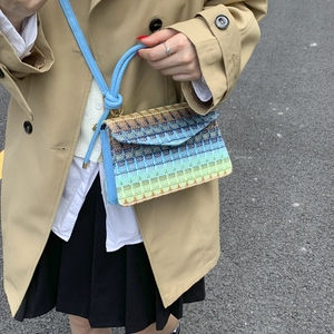 Colorful woven crossbody bag with blue strap and knot handle for casual summer style