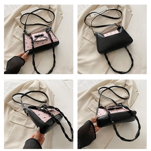Detailed views of a pink pleated dumpling bag with black bow print and heart charm