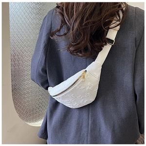 Detailed view of white half-moon chest bag with jacquard texture and golden zipper
