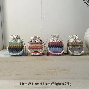 Chic woven drawstring bucket bags with pearl handles and colorful striped patterns