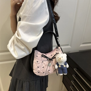 Pink and black crescent shoulder bag with bow details and a cute bear plush charm