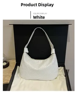 Detail of white woven leather texture on hobo bag with zip closure in a gift box