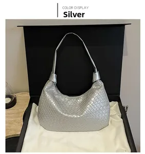 Detail of silver woven texture hobo bag showing metallic finish and intrecciato pattern