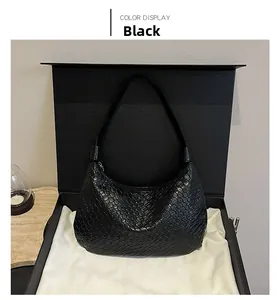 Detail of woven black faux leather hobo bag with intricate texture and chic shoulder strap