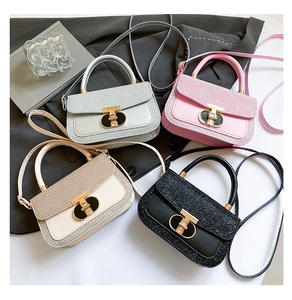 Macro shot of stylish handbag metal twist locks in silver, pink, beige, and black