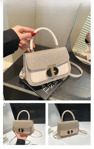 Detail of elegant gold glitter fabric flap and T-shaped metal twist lock closure