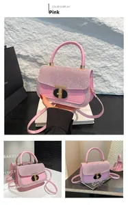 Close-up of pink sequined small square bag with metal clasp and leather handle