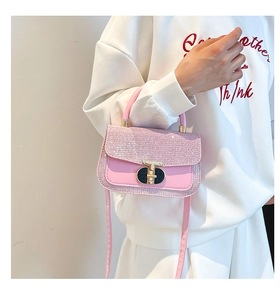 Close-up of pink sequin patchwork mini handbag featuring a golden turn-lock closure