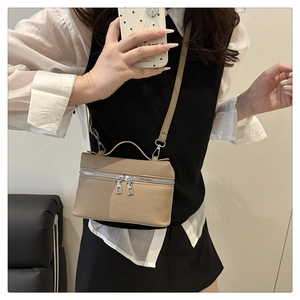 Khaki pebbled leather crossbody bag with dual silver zippers and adjustable strap