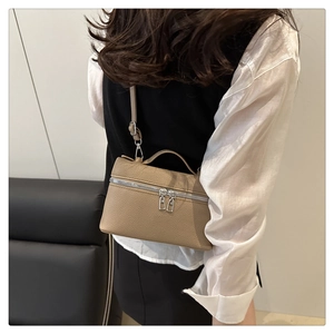 Detail of khaki lychee grain leather crossbody bag with silver double zipper closure