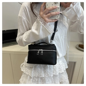 Litchi texture black box bag with silver zippers shown in a mirror selfie perspective