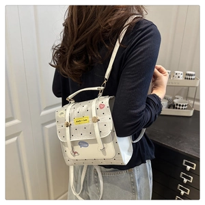 Polka dot backpack with lace trim and cute stickers shown on a person for daily use
