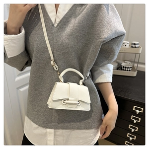 Mini white crossbody bag with lychee texture shown as a stylish handheld and shoulder bag