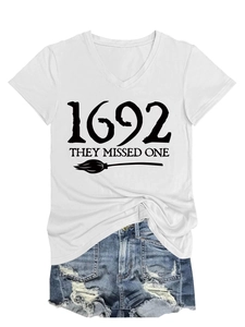 Detail of white V-neck T-shirt with 1692 text and broom print paired with denim shorts