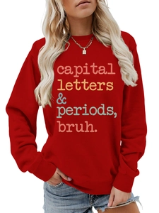 Close-up of red crewneck sweatshirt with colorful vintage slogan and ribbed cuffs