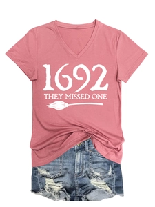 Detail of pink V-neck T-shirt with 1692 white graphic print and distressed denim shorts
