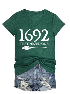 Close-up of the 1692 They Missed One print on a dark green V-neck Halloween t-shirt