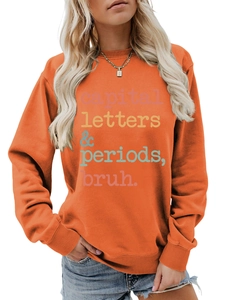 Close-up of orange sweatshirt with colorful capital letters and periods bruh text print