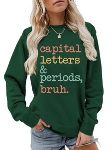 Detail of dark green sweatshirt featuring colorful capital letters and periods bruh print